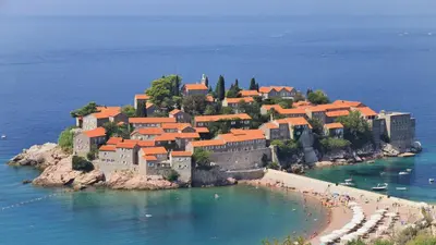 an island with a castle in the water at Apart SKY Residence with sea view in DELMAR in Budva