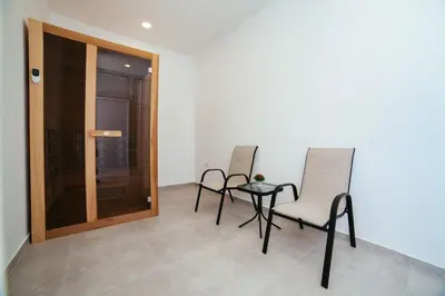 two chairs and a table in a room at Hotel Ambiente Ulcinj in Ulcinj