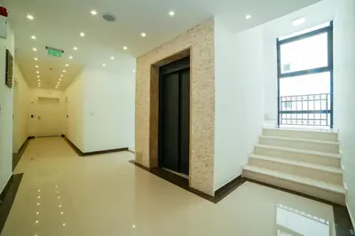 a hallway of a building with stairs and a window at Hotel Ambiente Ulcinj in Ulcinj