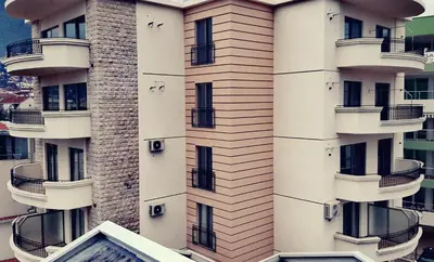 a building with balconies on the side of it at Apolon Apart in Bar, Susanj