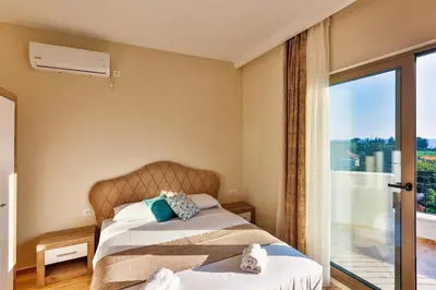 a bedroom with a bed and a window at Apolon Apart in Bar, Susanj