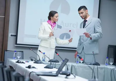 a man and a woman standing in front of a table at Hotel Aurel in Podgorica