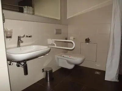 a bathroom with a sink and a toilet at Hotel Aurel in Podgorica