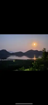 a view of a sunset with the sun in the sky at Skadar lake house Bobija in Podgorica