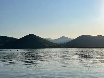 a large body of water with mountains in the background at Skadar lake house Bobija in Podgorica