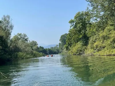 a group of people kayaking down a river at Skadar lake house Bobija in Podgorica
