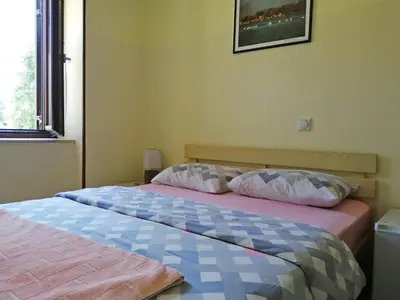 a bedroom with a bed with two pillows on it at Hotel Pelikan in Virpazar