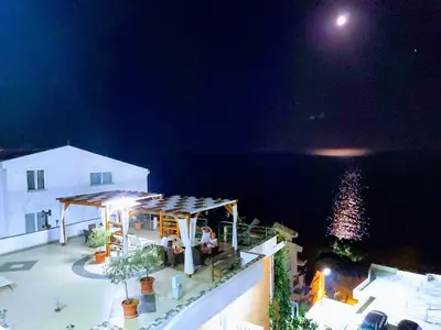 a night view of a house with a gazebo at Sun Apartments in Ulcinj