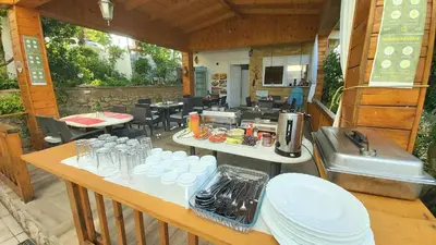 an outdoor kitchen with tables and chairs and a restaurant at Sun Apartments in Ulcinj