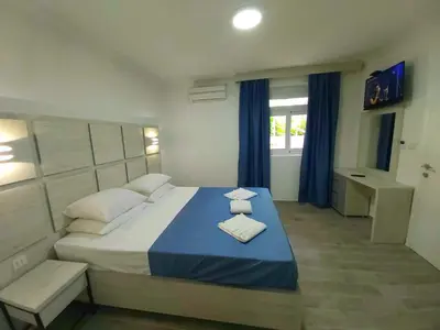 a bedroom with a large bed with two towels on it at Sun Apartments in Ulcinj