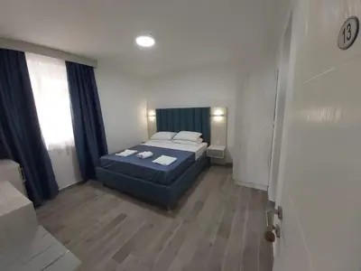 a small bedroom with a bed and a window at Sun Apartments in Ulcinj