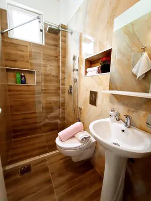 a bathroom with a sink and a toilet and a shower at Sun Apartments in Ulcinj