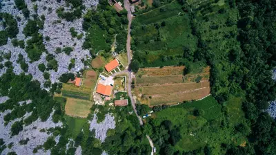 an aerial view of a farm in the middle of a field at Apartments EcoNature in Virpazar
