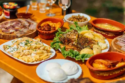 a table with many different types of food on it at Apartments EcoNature in Virpazar
