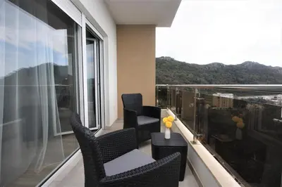 a balcony with chairs and a view of a city at Rafailovici Studio Vita in Rafailovici