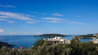 a view of a large body of water with a building at Rafailovici Studio Vita in Rafailovici