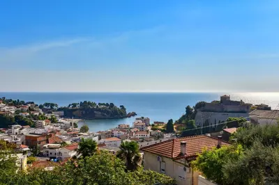 a view of a town with the ocean in the background at Apartments Hillside in Ulcinj