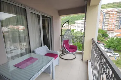 a balcony with a table and chairs on a balcony at Seaside Apartments Petrovac in Petrovac na Moru