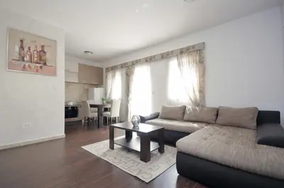 a living room with a couch and a table at Seaside Apartments Petrovac in Petrovac na Moru