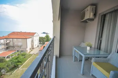 a balcony with a table and a view of the ocean at Seaside Apartments Petrovac in Petrovac na Moru