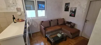 a living room with a couch and a table at Apartment Boki in Budva
