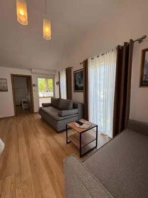 a living room with a couch and a table at Apartments Villa Marija in Petrovac na Moru