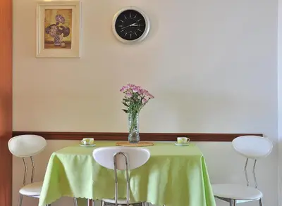 a table with a vase of flowers on it at Apartments Villa Marija in Petrovac na Moru