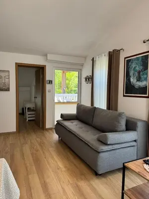 a living room with a couch and a table at Apartments Villa Marija in Petrovac na Moru