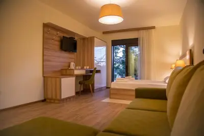 a hotel room with a bed and a desk at Apartments E&S in Ulcinj