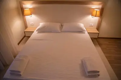 a large bed in a room with two towels on it at Apartments E&S in Ulcinj