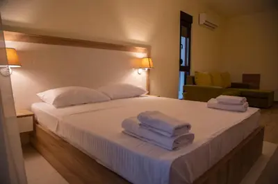 a bedroom with a bed with towels on it at Apartments E&S in Ulcinj
