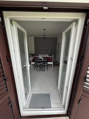 an open door to a dining room with a table at Apartments Samardzic in Kotor