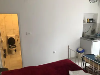 a bathroom with a toilet and a sink in a room at Apartments Samardzic in Kotor