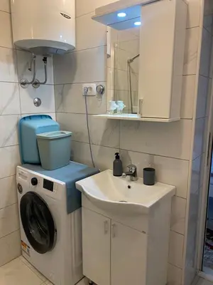 a bathroom with a washing machine and a sink at Apartments Samardzic in Kotor