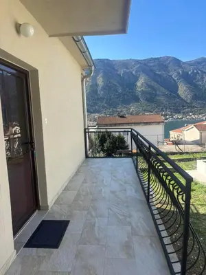 a balcony of a house with a view of the mountains at Apartments Samardzic in Kotor