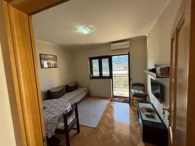 a small room with a bed and a window at Apartments Samardzic in Kotor