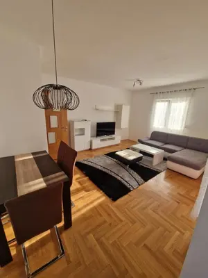 a living room with a couch and a table at Apartment For a Day in Podgorica