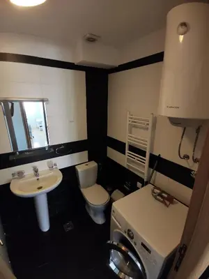 a small bathroom with a toilet and a sink at Apartment For a Day in Podgorica