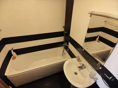 a bathroom with a sink and a bath tub at Apartment For a Day in Podgorica