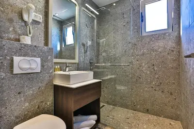 a bathroom with a sink and a shower at Hotel Bono in Budva