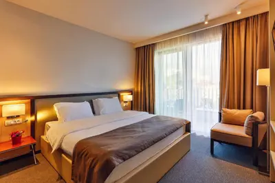 a hotel room with a large bed and a window at Hotel Bono in Budva