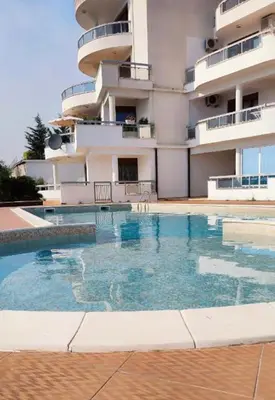 a swimming pool in front of a building at Lilo in Dobra Voda