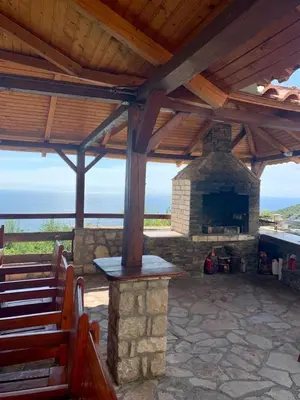 an outdoor altar with a stone fireplace and benches at Lilo in Dobra Voda