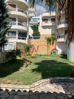 a playground in a yard in front of a building at Lilo in Dobra Voda