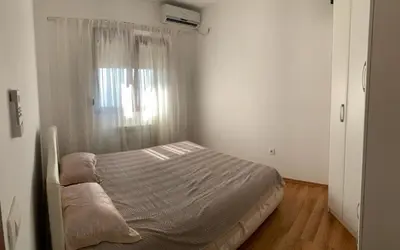 a small bedroom with a bed with a window at Lilo in Dobra Voda