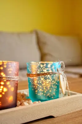 two candles sitting on a table with peanuts at Apartments Stella in Virpazar