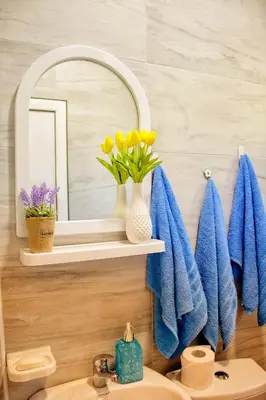 a bathroom with a sink and a mirror and towels at Apartments Stella in Virpazar