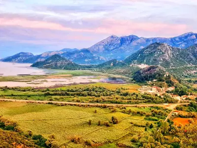 an aerial view of a valley with a river and mountains at Auto camp Radoman in Virpazar