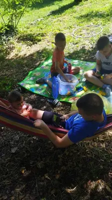 a group of children sitting on a blanket at Auto camp Radoman in Virpazar