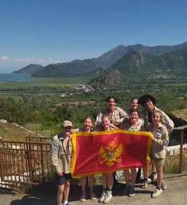 a group of people holding a flag on a hill at Auto camp Radoman in Virpazar